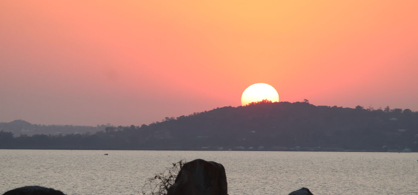 Sun setting behind granite outcrops on the shore of Lake Victoria